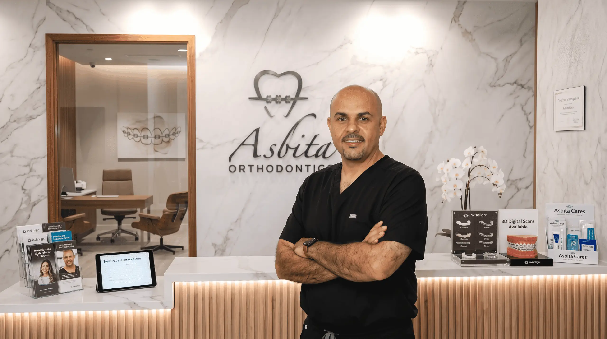 Dr. Asbita at the front desk of the Asbita Orthodontics office in Hockley, Texas